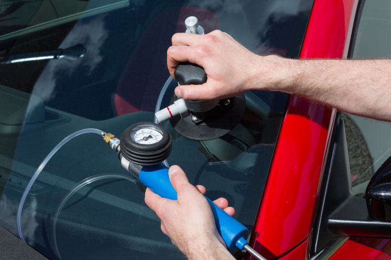 Close up of a windshield chip being repaired